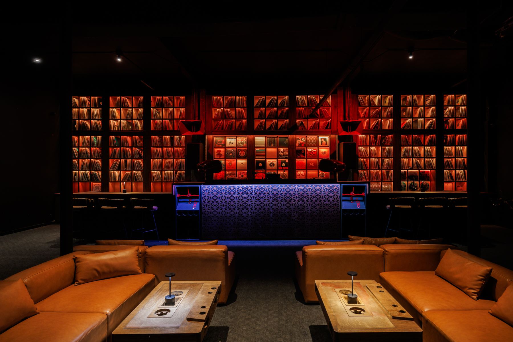 Leather booths and tables under the record wall